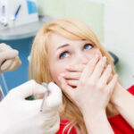 A woman experiences dental anxiety while in the chair