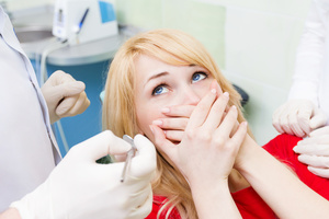 A woman experiences dental anxiety while in the chair