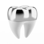 A photo of a tooth with a silver dental crown.